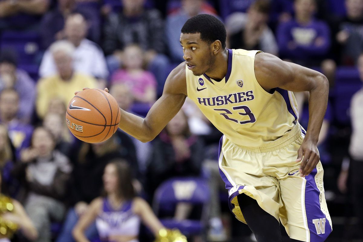 Washington’s C.J. Wilcox races up the court against No. 15 Colorado in Sunday’s game in which he had a career-high seven 3-pointers. (Associated Press)