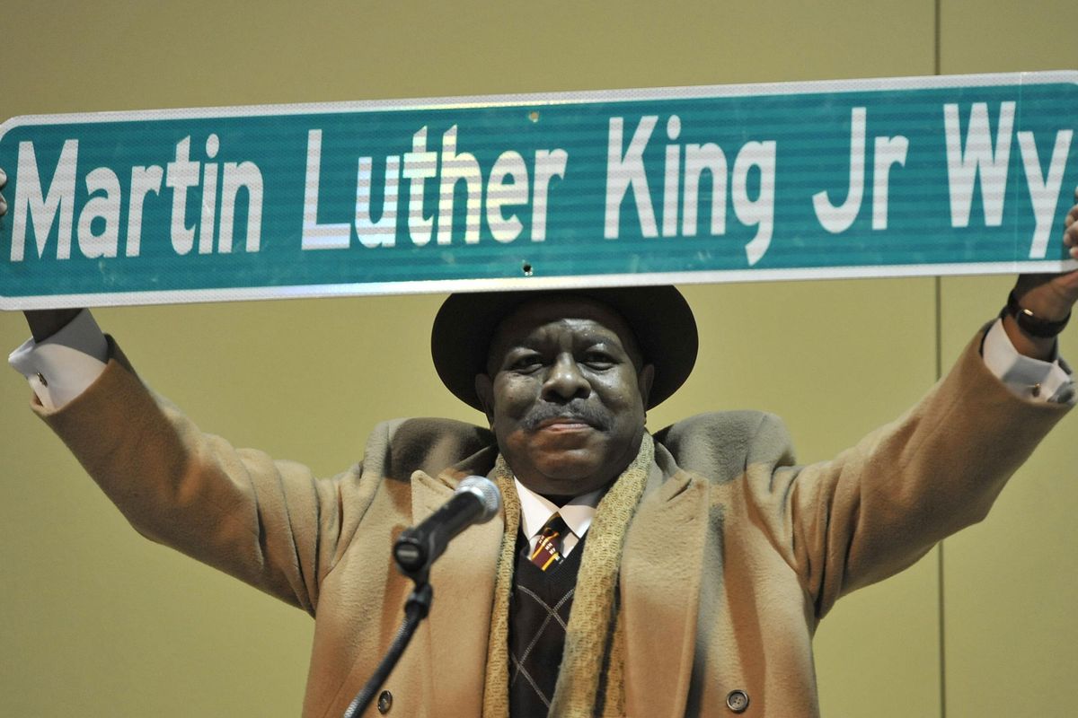Ivan Bush proudly displays a Martin Luther Kin Jr. Way street sign to the thousands gathered at the Spokane Convention Center for the MLK Jr. Unity March, Jan. 16, 2011 in downtown Spokane, Wash. (Dan Pelle / The Spokesman-Review)