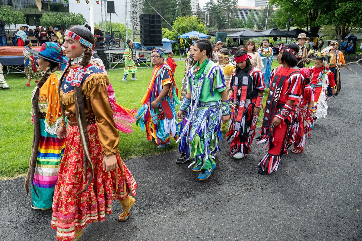 Native Americans in full regalia dance during the grand entrance at the Two-Spirit Powwow on Friday in Riverfront Park.  (COLIN MULVANY/THE SPOKESMAN-REVIEW)