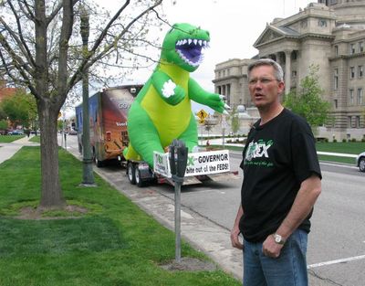 GOP gubernatorial candidate Rex Rammell, right, shows off the new 16-foot inflatable tyrannosaurus rex that's his latest campaign gimmick, along with his new campaign slogan,