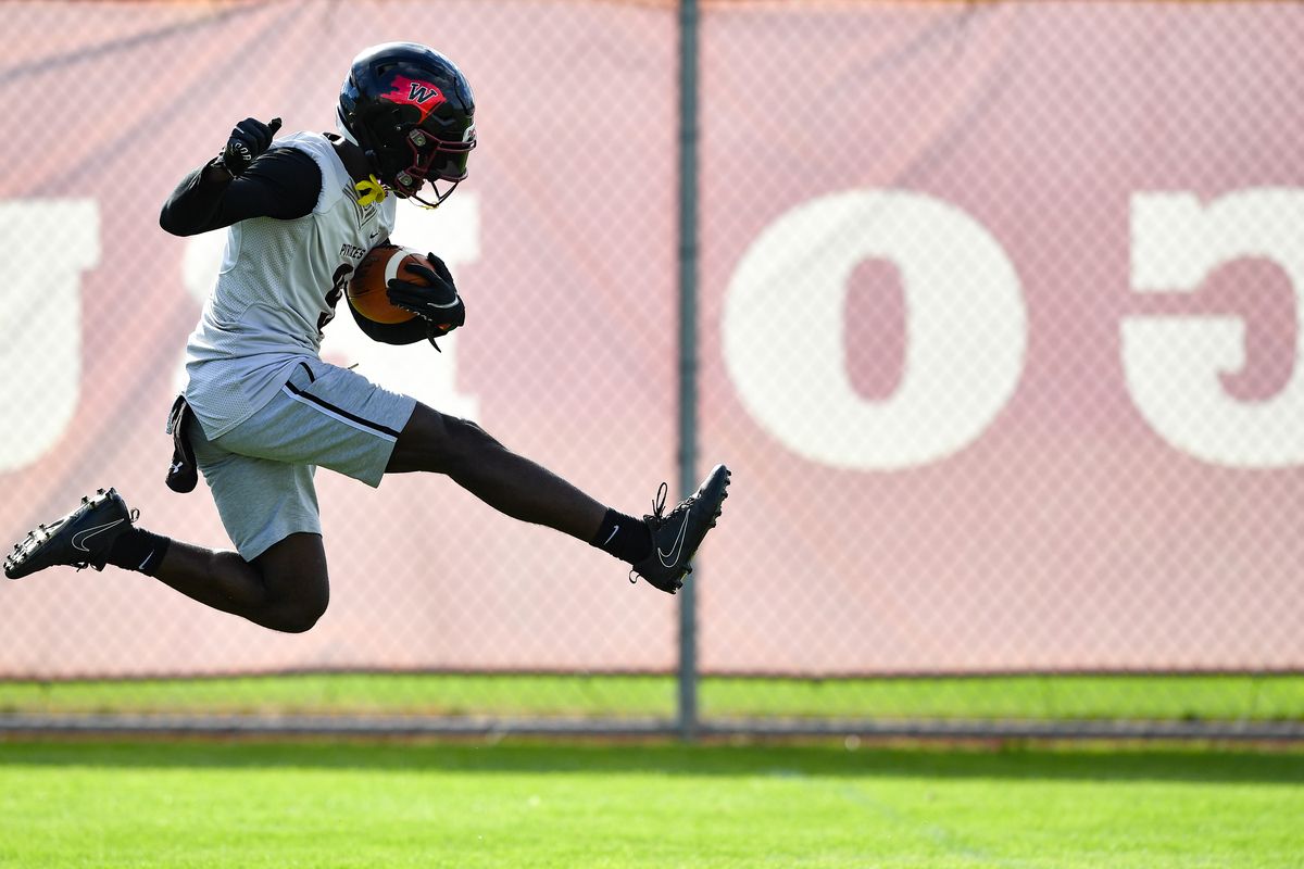 Whitworth running back Solo Hines (9) flies through the air as he runs downfield during the team’s first day of fall camp on Thursday, Aug. 10, 2023, at Whitworth University in Spokane, Wash.  (Tyler Tjomsland/The Spokesman-Review)