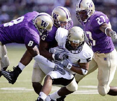 
Daniel Smith gets a catch last Saturday against the Huskies. 
 (Associated Press / The Spokesman-Review)