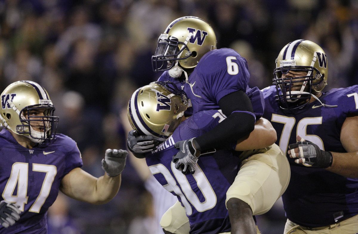 Washington’s Brandon Johnson (6) celebrates with teammates after scoring during a 35-28 loss to Stanford on Sept. 27. (Associated Press / The Spokesman-Review)