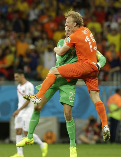 Netherlands backup goalie Tim Krul makes one final save, catching Dirk Kuyt in his arms after clinching win over Costa Rica with two saves in penalty shootout. (Associated Press)