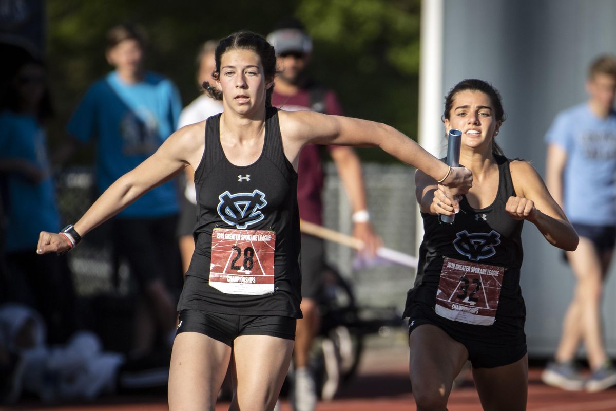 In the first leg of the 4A Girls 4X100 Relay, Central Valley’s Marissa Orrino, on right, hands the baton to teammate Molly McCormick. CV won the race during the 2019 GSL League Championship track meet held Friday, May 10, 2019 at Central Valley High School. (Colin Mulvany / The Spokesman-Review)