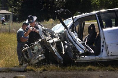 
An ISP trooper photographs one of two cars involved in a fatal collision on I-90 Saturday near Post Falls. 
 (Jed Conklin / The Spokesman-Review)