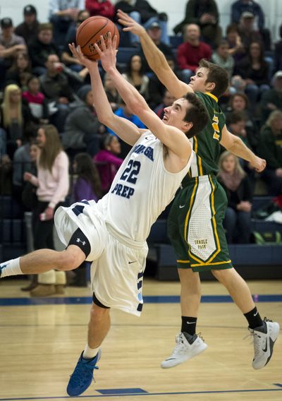 Gonzaga Prep's Frankie Hoerner takes a shot as Shadle's Eric Cooper tries to defend in Friday’s game. (Colin Mulvany)