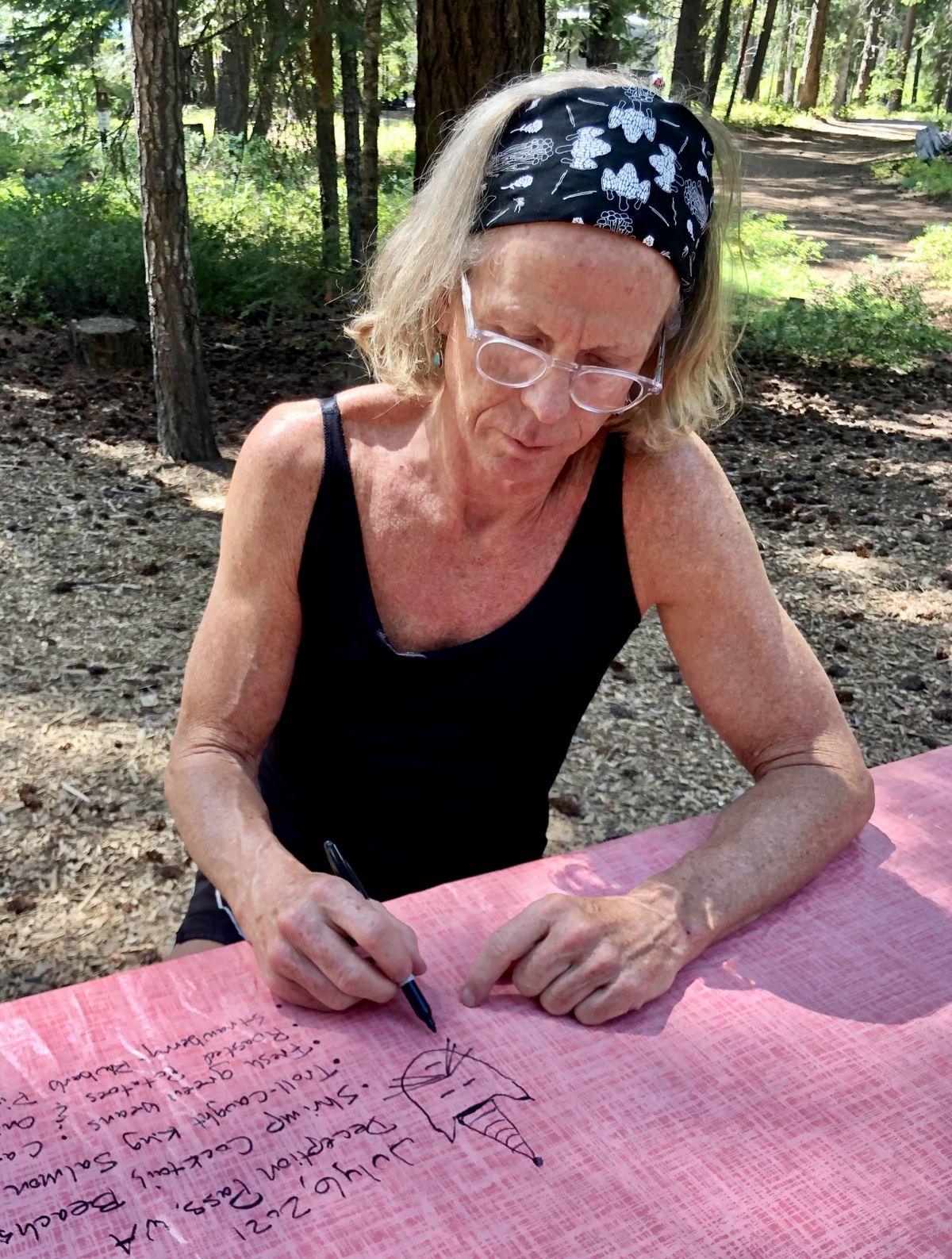 John writes out his birthday meal on the new tablecloth while staying at Lake Wenatchee State Park. (Leslie Kelly)