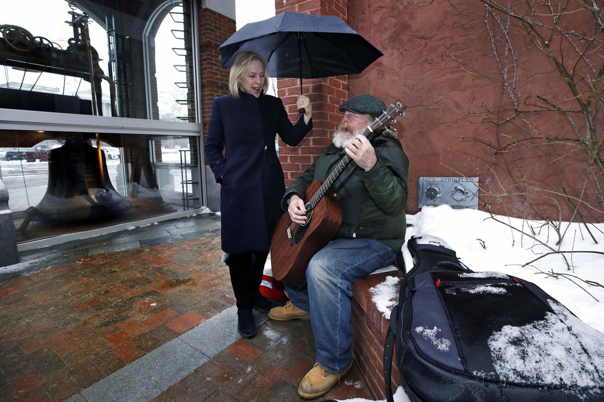 Sen. Kirsten Gillibrand, D-NY, sings along with street musician Kevin Clark, who plays a Cat Stevens’ song, while touring Main Street in Concord, N.H., Friday, Feb. 15, 2019. Gillibrand visited New Hampshire as she explores a 2020 run for president. Clark said he’s performed on the street since 2011. (Charles Krupa / Associated Press)