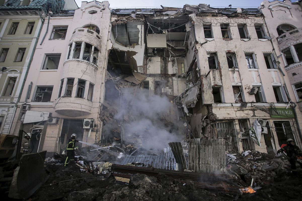 Firefighters extinguish an apartment house after a Russian rocket attack in Kharkiv, Ukraine