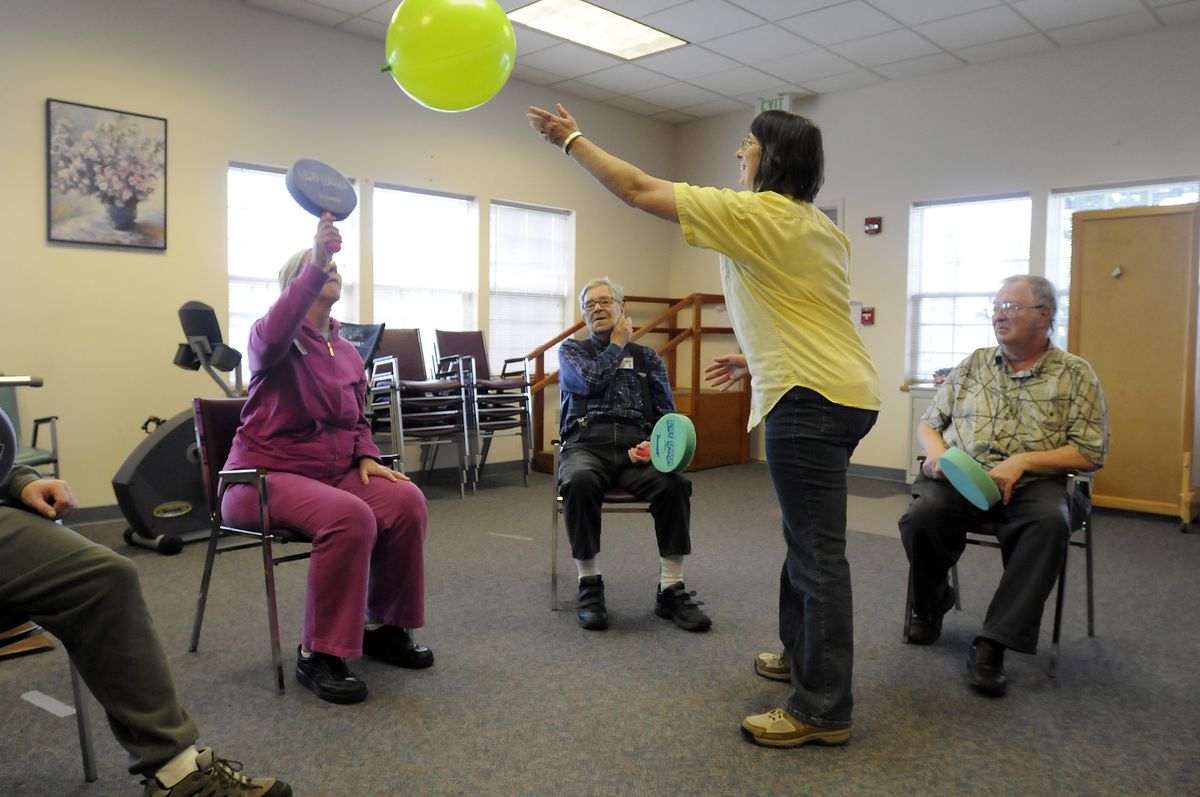 The Spokesman-Review Rehabilitation aide Ruth Berning leads a game with clients at Providence Adult Day Health last week. (Jesse Tinsley / The Spokesman-Review)