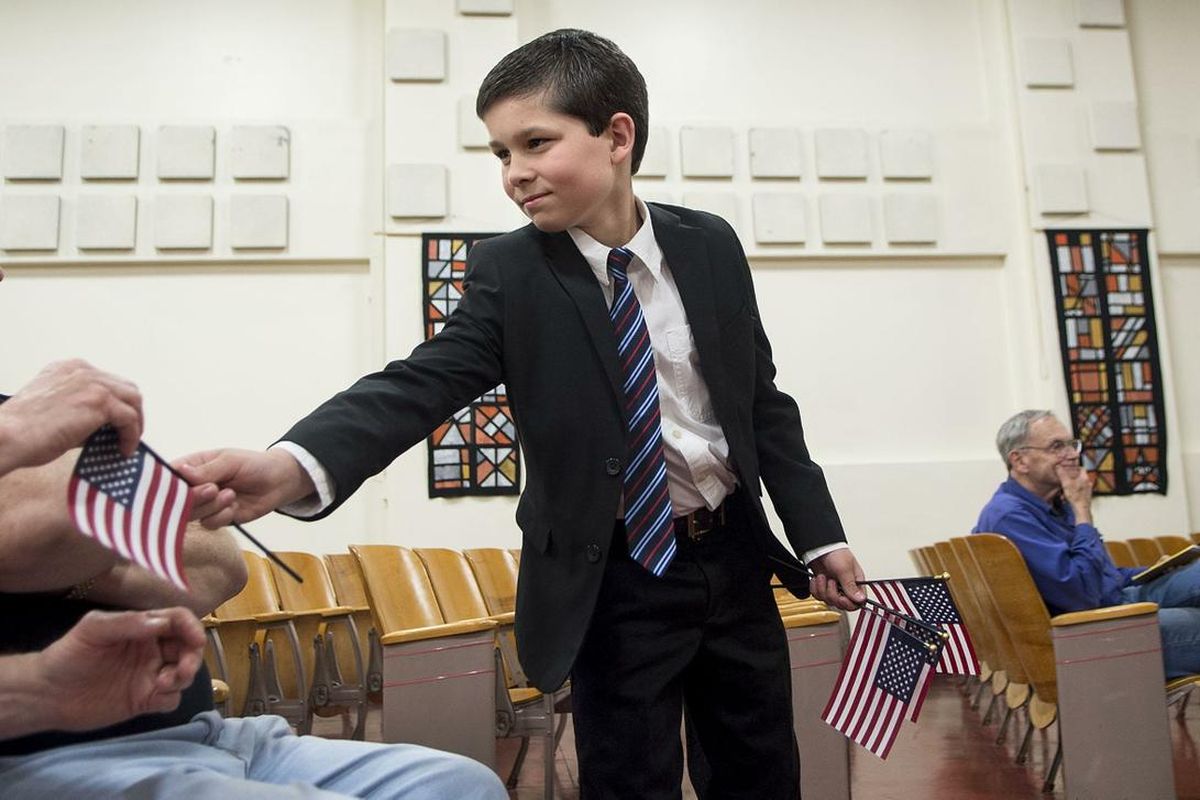 Nine-year-old Ryan Durbin of Protect My Idaho handed out flags and urged everyone to vote before a candidates forum at Priest River Junior High School sponsored by the Bonner County Republican Central Committee on May 4. (Kathy Plonka / The Spokesman-Review)