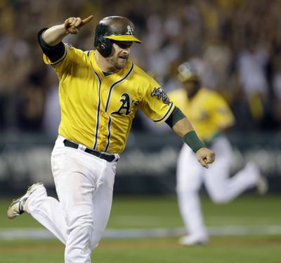 Stephen Vogt celebrates on his way to first base after his game-winning single in the ninth inning. (Associated Press)