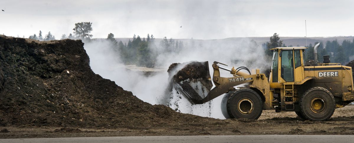 A front loader gathers a bucket of steaming compost for relocation at the Barr-Tech site near Fishtrap Lake in Lincoln County on Thursday. (Dan Pelle)