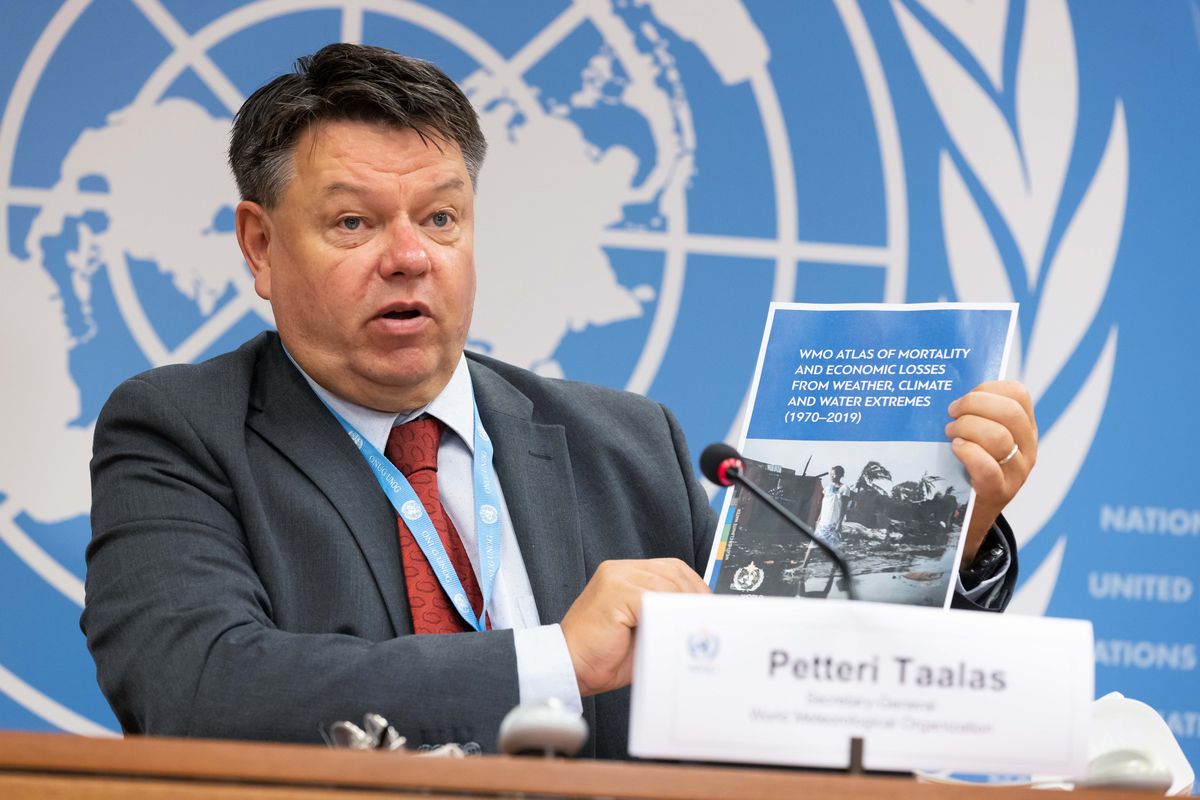 Secretary-General of the World Meteorological Organization (WMO) Petteri Taalas displays a report, during a press conference at the Palais des Nations, in Geneva, Wednesday, Sept. 1 2021.  (Pierre Albouy)