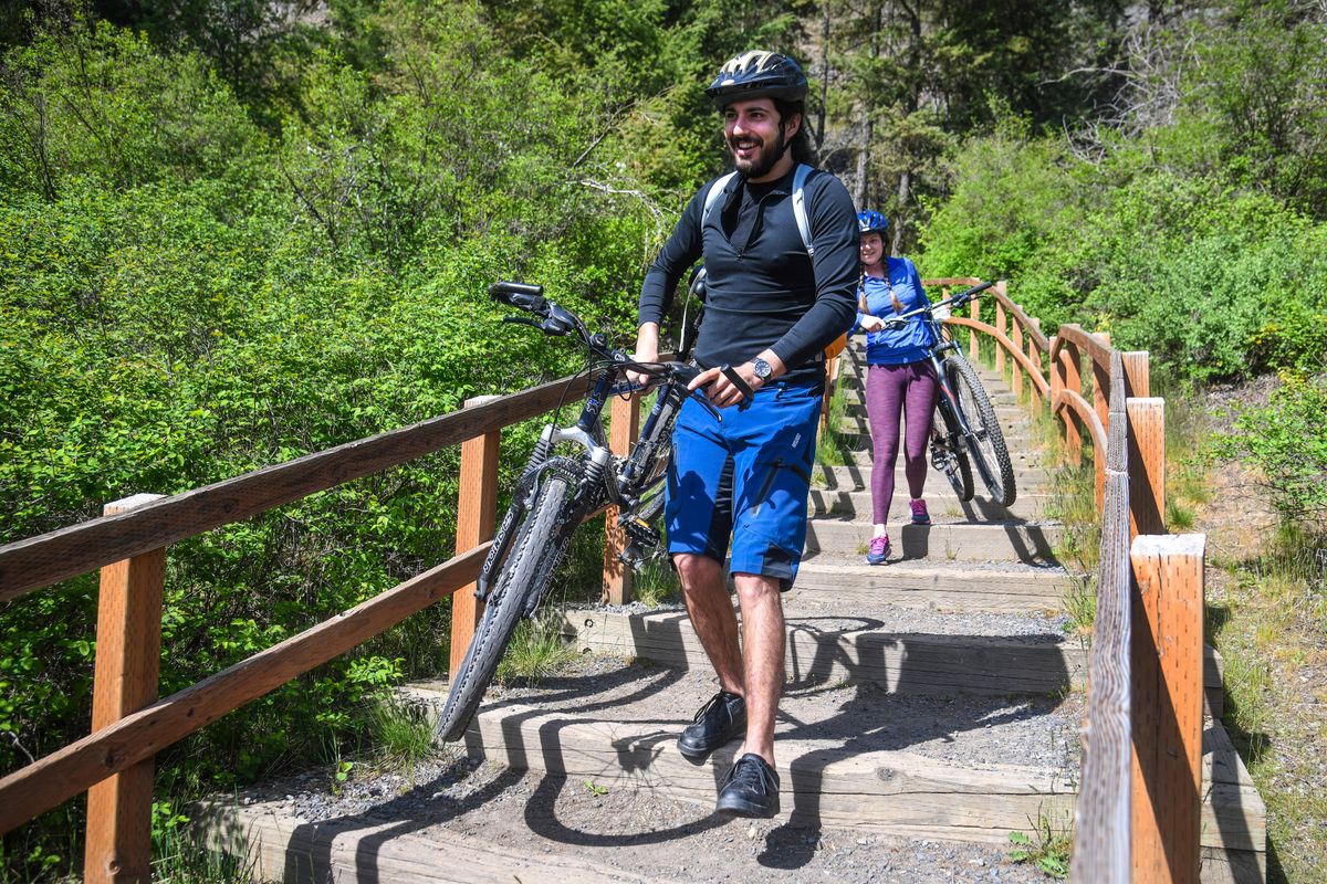 Cayman Strong, left, and Erin Cameron explore Riverside State Park with their bikes near the Bowl & Pitcher area, Tuesday, May 5, 2020, on the first day of state parks reopening because of the COVID-19 pandemic. (Dan Pelle / The Spokesman-Review)