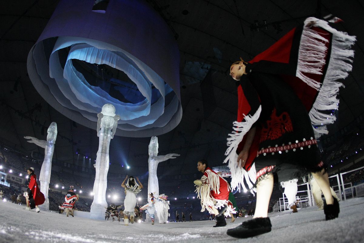 Aboriginal people of Canada dance around Welcoming Poles during the opening ceremony for the Vancouver 2010 Olympics on Friday, Feb. 12, 2010. (Gerry Broome / Associated Press)