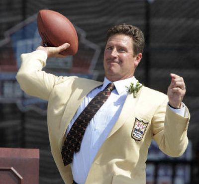 
Former Dolphins quarterback Dan Marino throws a pass to former teammate Mark Clayton at the end of his speech on Sunday.
 (Associated Press / The Spokesman-Review)