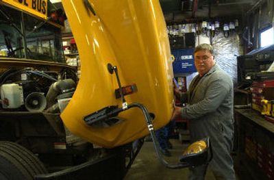 
Mechanic Glenn Cutler works on a school bus in the Post Falls School District transportation shop Tuesday. The district plans  to expand the shop with money from a newly approved levy. 
 (Jesse Tinsley / The Spokesman-Review)