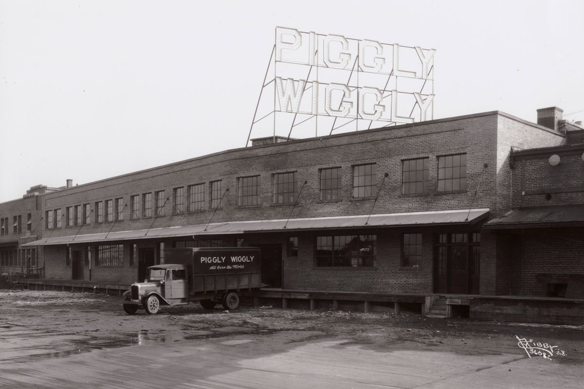 1928: The Piggly Wiggly warehouse at 28 E. Riverside Ave. in Spokane served the company at a time of explosive growth of the company and the industry as a whole. George B. Christensen of Utah was guiding the Piggly Wiggly grocery chain at that time. Western Piggly Wiggly merged the MacMarr Stores chain in 1929 which was later bought by Safeway around 1931.  (Libby Photo Collection Courtesy of Northwest Museum of Arts and Culture)