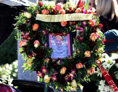 
A wreath with the picture of Mario Danelo sits outside the church where his funeral was held. 
 (Associated Press / The Spokesman-Review)
