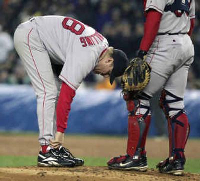 
Curt Schilling tends to his right ankle in Game 6 of ALCS. Saturday he again had his ankle tendon sutured.
 (Associated Press / The Spokesman-Review)