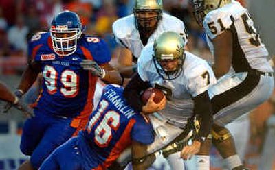 
Idaho quarterback Michael Harrington is sacked for a first-half loss by Boise State's Gabriel Franklin.
 (Christopher Anderson / The Spokesman-Review)