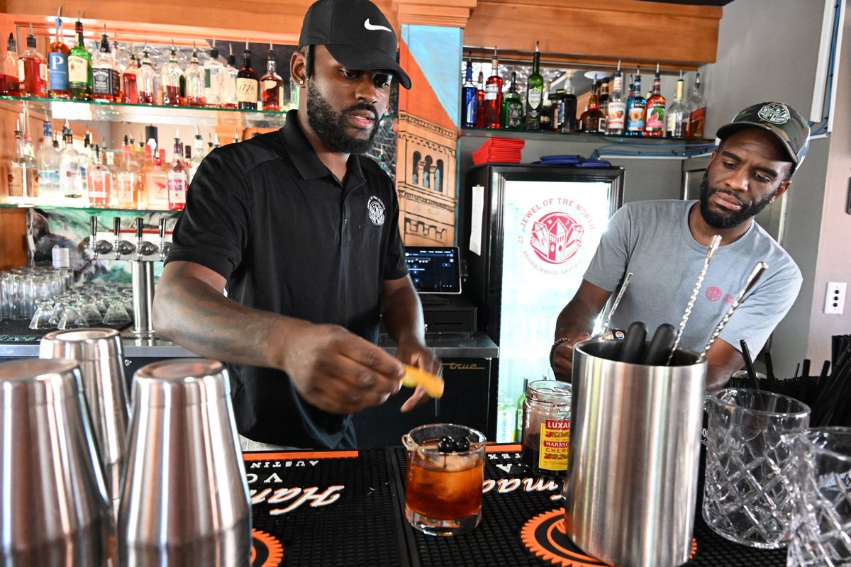 AJ Hansen, left, makes an old-fashioned as Brooks Thomas stands by to help in the cozy upstairs bar at Jewel of the North, a bistro inside the historic house at Pacific Avenue and South Cannon Street in Browne’s Addition in Spokane.  (Jesse Tinsley/THE SPOKESMAN-REVIEW)