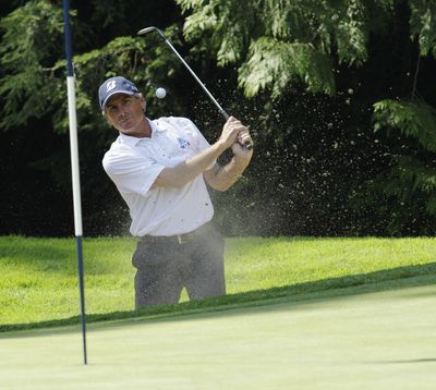 Fred Couples hits from the bunker on the 15th hole in the third round of the U.S. Senior Open. (Associated Press)