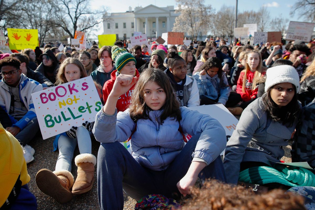 In this March 14, 2018 file photo, young demonstrators hold a rally in front of the White House in Washington. Another wave of school walkouts is expected as students honor victims of gun violence and push for gun control. (Carolyn Kaster / Associated Press)