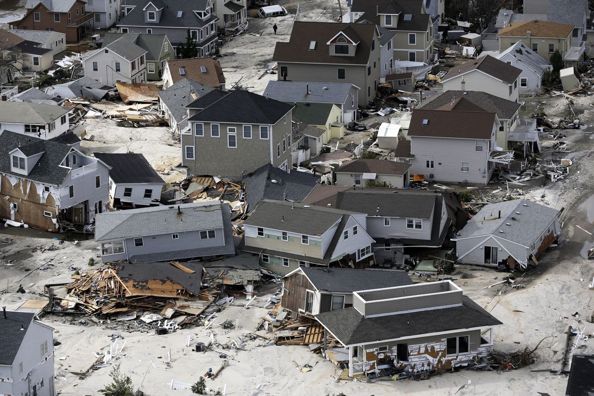 This aerial photo shows destroyed homes left in the wake of superstorm Sandy on Wednesday, Oct. 31, 2012, in Seaside Heights, N.J. New Jersey got the brunt of Sandy, which made landfall in the state and killed six people. More than 2 million customers were without power as of Wednesday afternoon, down from a peak of 2.7 million. (Mike Groll / Associated Press)