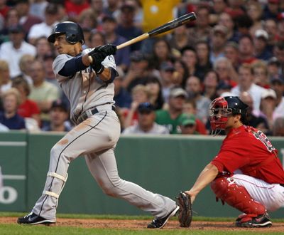 Seattle Mariners' Ronny Cedeno watches the flight of his two-run home run as Boston Red Sox catcher George Kottaras looks on during the fourth inning of the July 3, 2009, baseball game at Fenway Park in Boston. (Associated Press)