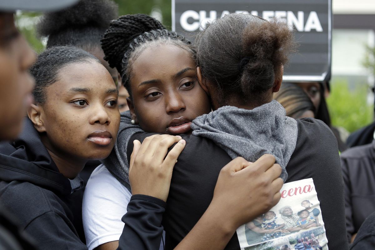 Relatives embrace at a memorial outside where a pregnant mother was shot and killed by police, Tuesday, June 20, 2017 in Seattle. Police officers shot and killed 30-year-old Charleena Lyles on June 18 after authorities said Lyles confronted the officers with a knife. (Elaine Thompson / Associated Press)