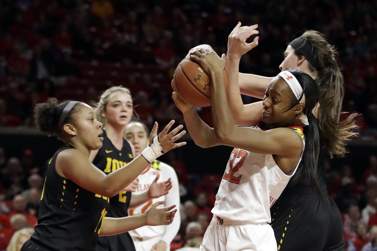 Maryland guard Shatori Walker-Kimbrough, second from right, grabs a rebound in front of Iowa guard Tania Davis, left, and forward Megan Gustafson, right, in the second half of an NCAA college basketball game, Sunday, Jan. 29, 2017, in College Park, Md. (Patrick Semansky / Associated Press)