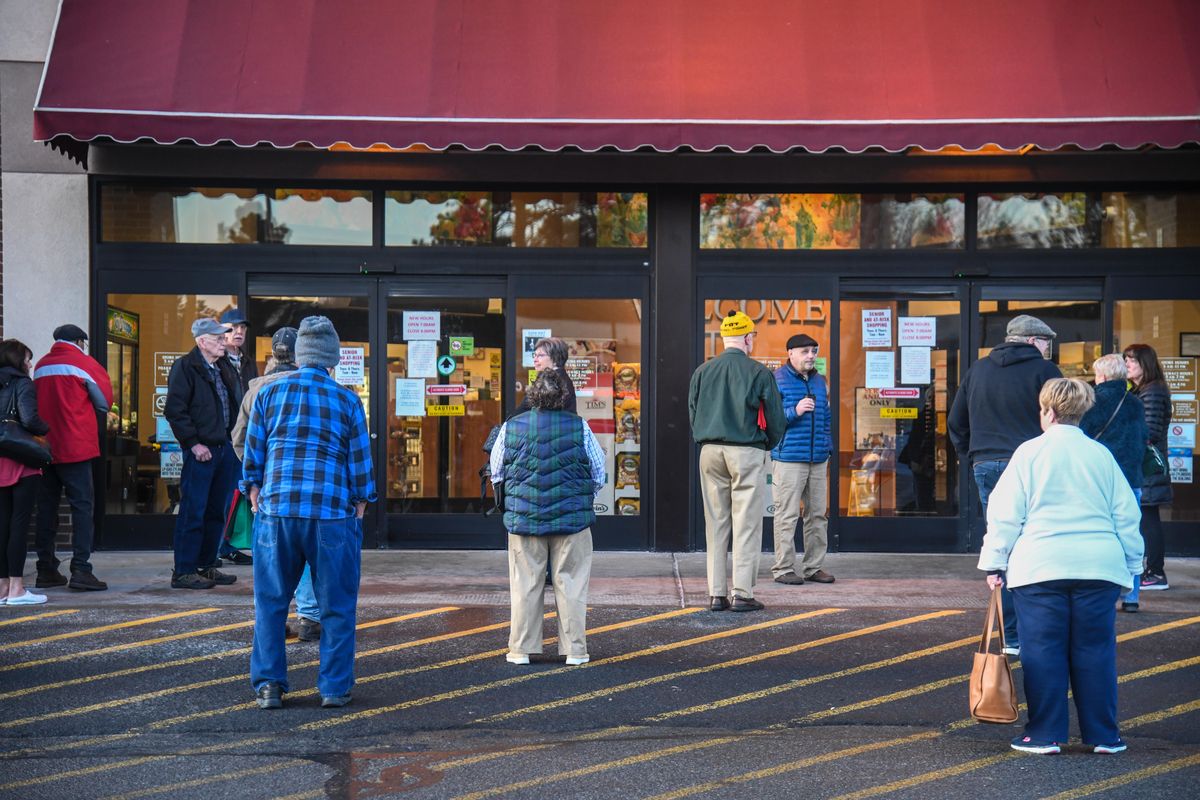 Rosauers customers line up before the 7 a.m. opening for senior and at-risk shopping at the grocery store on 29th Avenue, Thursday, March 19, 2020, in Spokane, Wash. (Dan Pelle / The Spokesman-Review)