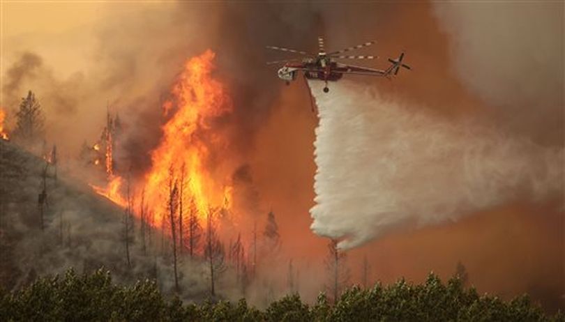 Helicopters battle the 64,000 acre Beaver Creek Fire on Friday, Aug., 16, 2013 north of Hailey, Idaho. A number of residential neighborhoods have been evacuated because of the blaze.(AP Photo/Times-News, Ashley Smith) (AP/Times-News / Ashley Smith)