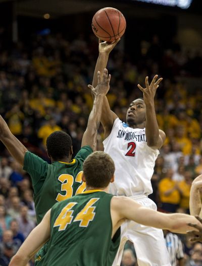 San Diego State’s Xavier Thames shoots over outstretched arm of TrayVonn Wright of North Dakota State. (Colin Mulvany)