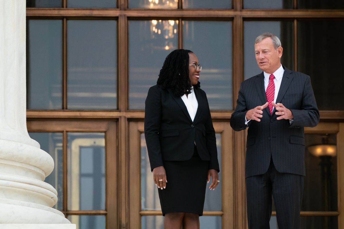 Associate Justice Ketanji Brown Jackson is escorted out after an investiture ceremony by Chief Justice John G. Roberts Jr. at the Supreme Court on Sept. 30 in Washington.  (Elizabeth Frantz/For The Washington Post)