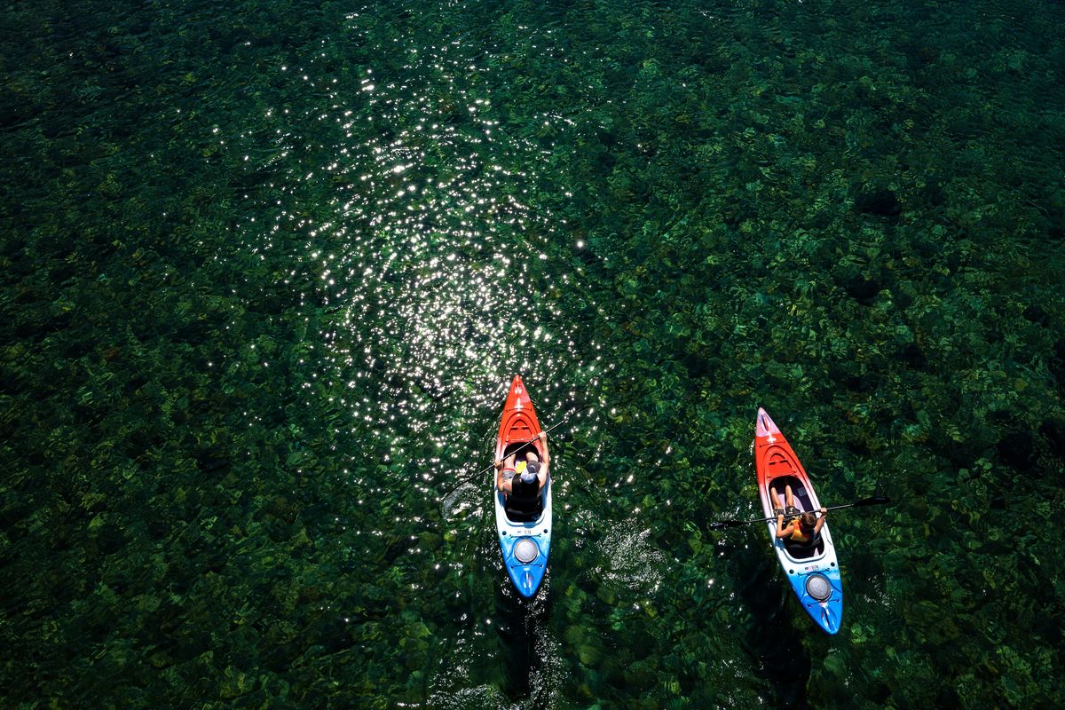 Tim Holman and his son Trevor, 9, kayak the Spokane River below Plante’s Ferry Stadium, in Spokane Valley last summer.  (COLIN MULVANY/THE SPOKESMAN-REVIEW)