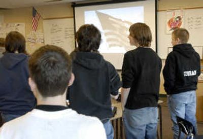The Spokesman=Review Eighth-grade students in David Cunningham's languate arts class recite the Pledge of Allegiance at the beginning of the morning broadcast of the news and weather at Greenacres Elementary.
(Photos by J. Bart Rayniak The Spokesman=Review / The Spokesman-Review)