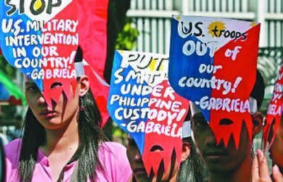 
Protesters in the Phillipines wear masks with anti-United States messages during a Feb. 2 demonstration to mark the 108th anniversary of the Filipino-American war. William F. Schulz, former head of Amnesty International USA, says injustices committed by the U.S. in its war on terror have served to intensify anti-American sentiments throughout the world. 
 (File Associated Press / The Spokesman-Review)