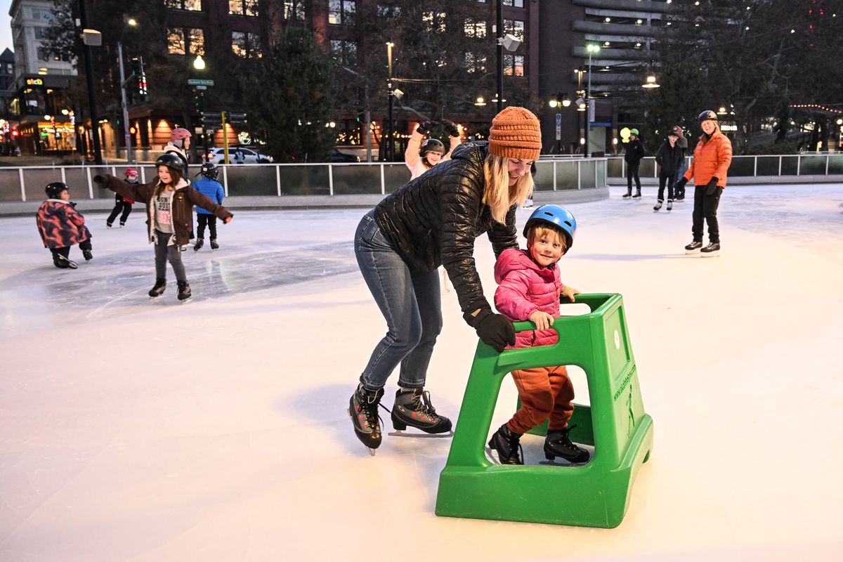 Kit Parker scoots her daughter Jamie, 4, around the ice on the Numerica Skate Ribbon, which opened for the first time this season on Friday.  (COLIN MULVANY/THE SPOKESMAN-REVIEW)