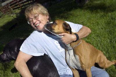 
Annette Wulff with dogs Corby, left, and Lady, was reunited with Lady thanks to a microchip implanted in the dog's neck. 
 (Holly Pickett / The Spokesman-Review)