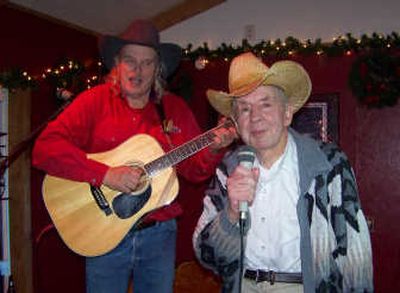 
Country music legend Slim Dossey, 89, right, entertains the crowd at the Captain Wheel's annual Christmas party on Sunday, accompanied by James Adams on the guitar.
 (HERB HUSELAND / The Spokesman-Review)