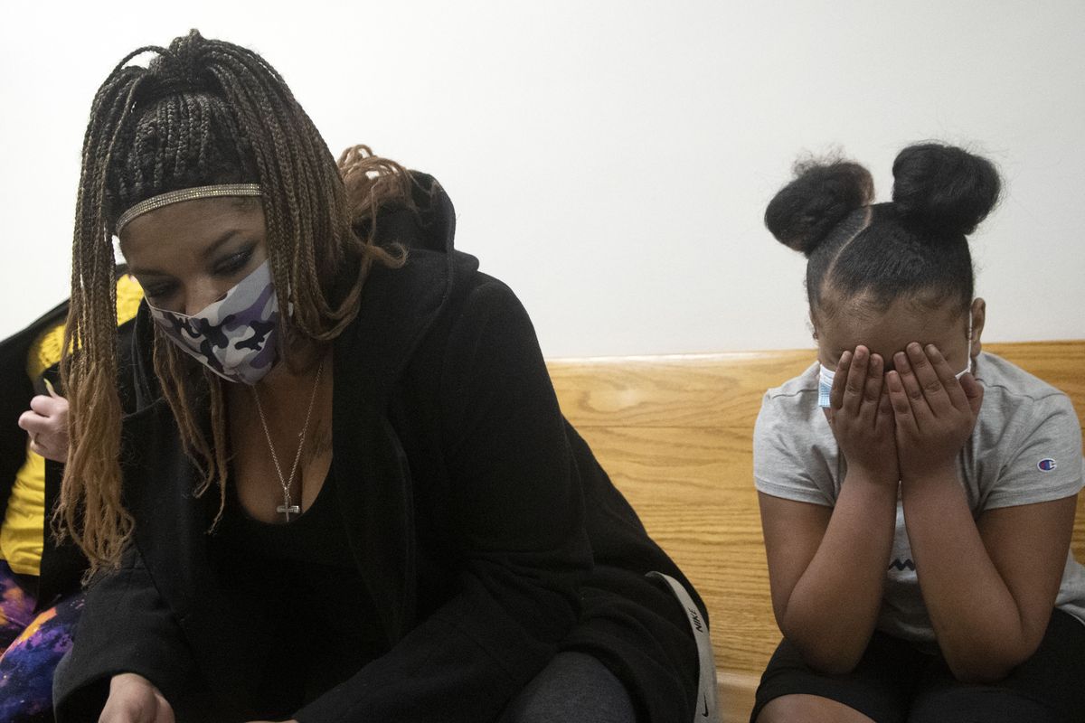 Nicole Ellis and her daughter Deja Jones, 9, sit outside a courtroom in which a jury found their son and brother, Tyler Rambo, not guilty of attempted murder or assault but guilty of several other counts related to two shootings on the Fourth of July 2019 .  (Kathy Plonka/The Spokesman-Review)