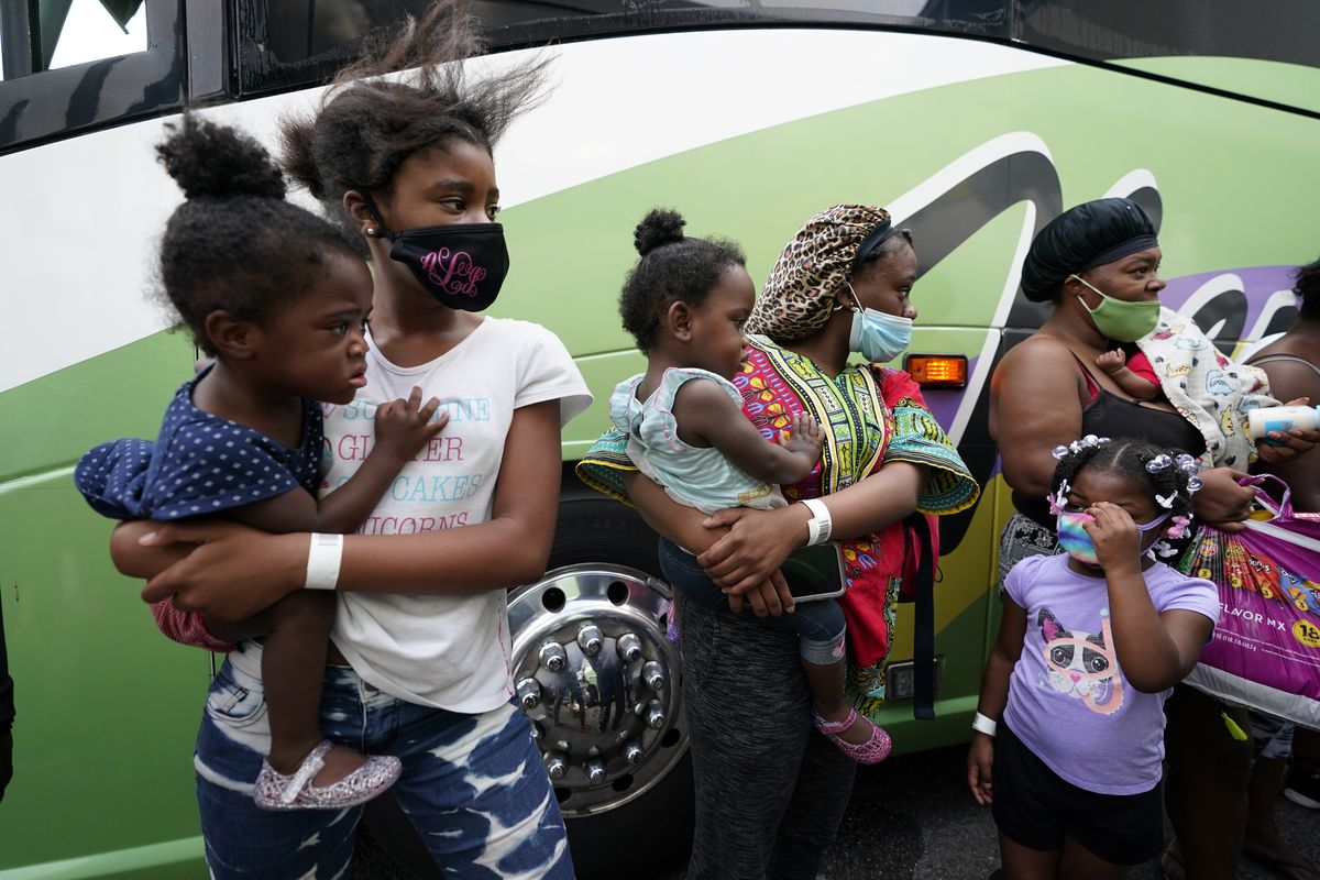 People line up to board buses to evacuate Lake Charles, La., Wednesday, Aug. 26, 2020, ahead of Hurricane Laura.  (Gerald Herbert)