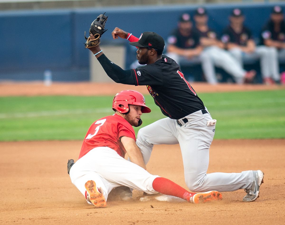 Vancouver Canadians Luis De Los Santos (1) guards his base against Kyle Datres during the final game in a six game series against the Spokane Indians on Sunday, Aug. 1, 2021 at Avista Stadium in Spokane Valley, Wash. The Indians fell 3-6 to the Canadians but won four out of six games of this series.  (Libby Kamrowski/ THE SPOKESMAN-REVIEW)