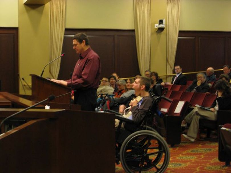 Samuel Page of Homedale testifies at a public hearing on Friday; with him is his son, Jonathan, who was disabled after a near-drowning accident when he was 15. Page told lawmakers, 